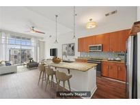 Bright, open kitchen featuring granite countertops, stainless steel appliances, and a large island with bar seating at 711 Cosmopolitan Ne Dr # 802, Atlanta, GA 30324