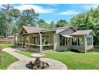 Charming one-story home with a covered porch and a decorative fountain at 161 Old Vandiver Dr, Canton, GA 30114