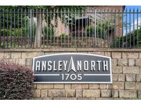 A sign for Ansley North 1705 with a stone brick wall and black iron fence at 1705 Monroe Ne Dr # E3, Atlanta, GA 30324