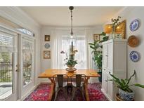 Bright dining area with a rustic wood table, ample natural light, and stylish decor at 3777 Peachtree Ne Rd # 1227, Brookhaven, GA 30319