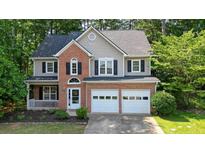 Charming two-story home features a brick facade, two-car garage, and a well-manicured front yard at 3366 English Oaks Nw Dr, Kennesaw, GA 30144