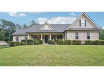 Charming home featuring beautiful stone and siding exterior with well-manicured landscaping at 2118 Braswell Ln, Loganville, GA 30052