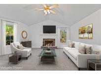 Bright living room features vaulted ceilings, fireplace, and neutral decor, creating an inviting atmosphere at 305 Bridgewater Ter, Canton, GA 30115