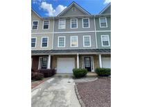 Charming townhome with a one car garage and a well maintained front yard at 6361 Redan Sq, Lithonia, GA 30058