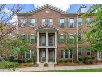 Charming two-story brick townhome with a meticulously landscaped yard at 531 Headwind Way, Alpharetta, GA 30005
