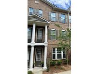 Charming brick townhouse featuring large windows and well-maintained landscaping at 531 Headwind Way, Alpharetta, GA 30005