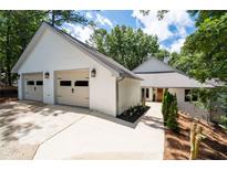 Lovely home featuring an attached two car garage and landscaped yard at 145 Mount Shasta Ln, Johns Creek, GA 30022