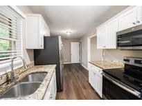 Well-lit kitchen featuring stainless steel appliances, granite countertops, and a sink with modern fixtures at 4009 Kirksford Dr, Decatur, GA 30035