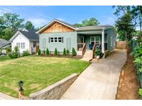 Charming bungalow with manicured lawn, shingle roof, and an inviting front porch at 853 Gaston Sw St, Atlanta, GA 30310