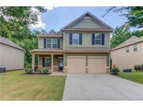 Charming two-story home with a two-car garage and traditional curb appeal at 2030 Beyers Landing Dr, Buford, GA 30519