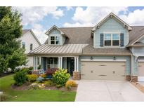 Charming two-story home featuring a well-manicured lawn and a two-car garage at 214 Misty View Dr, Canton, GA 30114