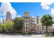 Beautiful low-rise condominium with brick and stucco exterior plus mature trees on a sunny day at 390 17Th Nw St # 2005, Atlanta, GA 30363