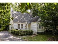 Charming cottage-style home with mature trees and a well-maintained yard provides great curb appeal at 348 7Th Ne St, Atlanta, GA 30308