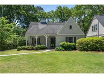 Charming home featuring a well-manicured lawn, covered front porch, and mature trees at 733 Greenview Ne Ave, Atlanta, GA 30305