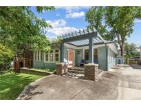 Charming home featuring a pergola-covered porch, well-maintained landscaping, and a welcoming entrance at 28 Peachtree Hills Ne Ave, Atlanta, GA 30305