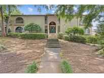 Inviting two-story condo with unique architecture, landscaping, and grand entrance staircase at 3236 Henderson Mill Rd # 1, Chamblee, GA 30341