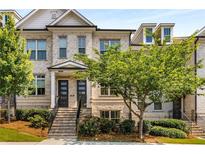 Beautiful townhome with traditional brick facade, manicured landscaping, and inviting entrance at 4358 Parkside Pl, Atlanta, GA 30342