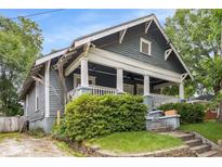 Charming home featuring a covered front porch, complemented by landscaped greenery and inviting curb appeal at 1148 Ne Hardee Ne St, Atlanta, GA 30307
