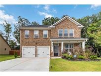 Charming two-story brick home with a well-manicured lawn and a two-car garage at 1469 Cliff View Ter, Conyers, GA 30012
