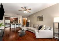 Spacious living room featuring hardwood floors, a ceiling fan, and an open layout to the kitchen at 898 Oak Sw St # 1301, Atlanta, GA 30310