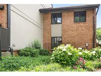 A brick building has multiple windows with green foliage and plants in front of it on a sunny day at 3268 Clairmont North Ne Rd, Brookhaven, GA 30329