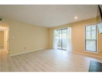 Bright living room with wood floors, sliding glass doors, and a window provide lots of natural light at 1102 Wynnes Ridge Se Cir, Marietta, GA 30067