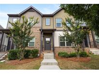 Attractive townhome with brick and siding, complemented by professionally landscaped front yard at 1005 Bayrose Cir # 5A, Atlanta, GA 30344