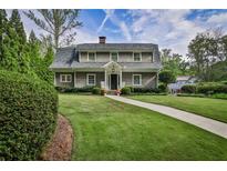 Charming two-story home with landscaped yard, walkway, and inviting front porch with rocking chairs at 1658 E Clifton Ne Rd, Atlanta, GA 30307