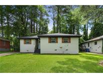 Charming single-story home featuring a freshly painted exterior and a well-manicured front yard at 3176 Pollard St, Atlanta, GA 30344