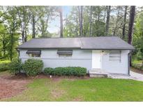 Charming single-story home with a well-maintained lawn and mature trees at 1079 Stonewall Drive Southeast, Atlanta, GA 30315