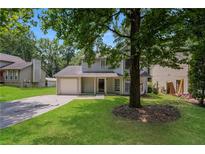 Charming two-story home with a well-maintained lawn and attached garage with driveway at 5107 Rails Way, Norcross, GA 30071