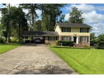 Charming two-story home with a long driveway and a covered carport at 529 Valley Woods Se Cir, Conyers, GA 30094