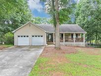 Charming single-story home featuring a covered front porch and an attached two-car garage at 250 Daileys Plantation Dr, Mcdonough, GA 30253
