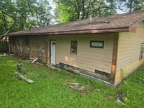 Back exterior of home needs repair and renovation to increase the appeal, along with the landscaping at 715 Plainville Sw Dr, Atlanta, GA 30331