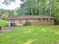 Single story home with a lawn and driveway, featuring mixed siding and brick at 715 Plainville Sw Dr, Atlanta, GA 30331