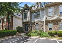 Charming townhome with stone and siding exterior, lush landscaping, and convenient parking at 1244 Harris Commons Pl, Roswell, GA 30076