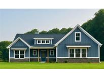 Charming blue home with white trim, stone accents, and a well-manicured lawn at 1273 Jersey Social Circle Rd, Covington, GA 30014