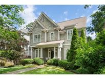 Charming two-story home with shingle siding, a manicured lawn, and mature landscaping at 785 Wilson Nw Rd, Atlanta, GA 30318