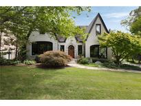 Charming home featuring a manicured lawn, mature trees, and a stone pathway leading to the front door at 1656 N Pelham Ne Rd, Atlanta, GA 30324