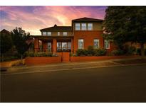 Stunning two-story red brick home with manicured landscaping and an inviting front porch at 185 Central Ave, Fayetteville, GA 30214