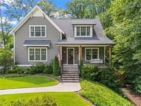 Charming craftsman home featuring a covered front porch, gray siding, manicured landscaping, and a welcoming facade at 2922 Parkridge Ne Dr, Brookhaven, GA 30319