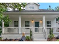 Charming home with a welcoming white front porch, columns, and a freshly landscaped yard at 1555 New Ne St, Atlanta, GA 30307