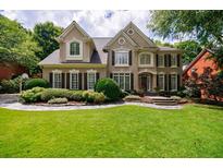 Elegant two-story home featuring a manicured lawn and a stone walkway leading to the front entrance at 4310 Granby Way, Marietta, GA 30062