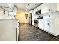 Well-lit kitchen features stainless steel appliances, white cabinetry, and a modern design at 1914 North Nw Ave, Atlanta, GA 30318