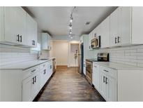 Bright kitchen features white cabinets, stainless steel appliances, and subway tile backsplash at 1914 North Nw Ave, Atlanta, GA 30318