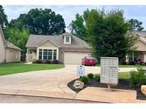 Charming single-story home with stone accents, lush lawn, and a well-maintained driveway at 245 Fenwick Cir, Mcdonough, GA 30253