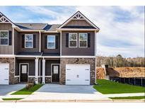 Charming townhome with brick and siding exterior, featuring an attached one-car garage and well-manicured lawn at 253 Ivey Ter # 48, Temple, GA 30179