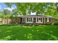 Charming brick home featuring a well-manicured lawn and a welcoming front porch at 2826 Summit Ridge Dr, Marietta, GA 30066