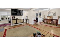 Inviting living room with hardwood floors, neutral walls, and access to the dining area at 4081 Riverlook Se Pkwy # 13, Marietta, GA 30067