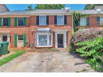 Charming brick townhome with a well-maintained front yard and covered entryway at 440 Forestgate Ct, Atlanta, GA 30350